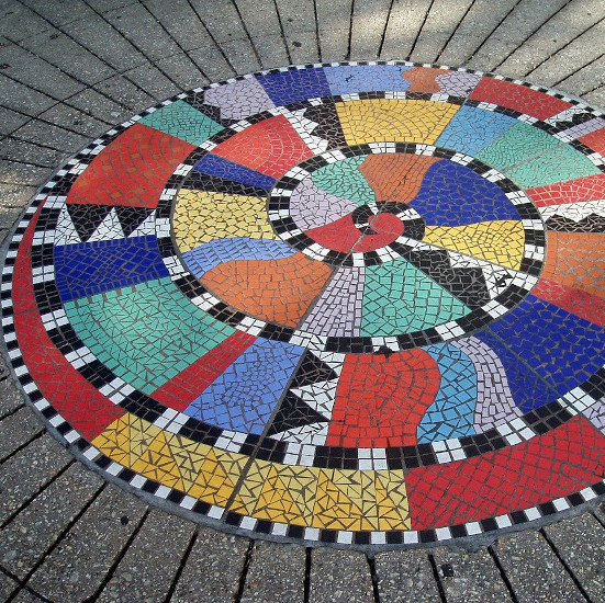 a spiral mosaic tile design on the ground